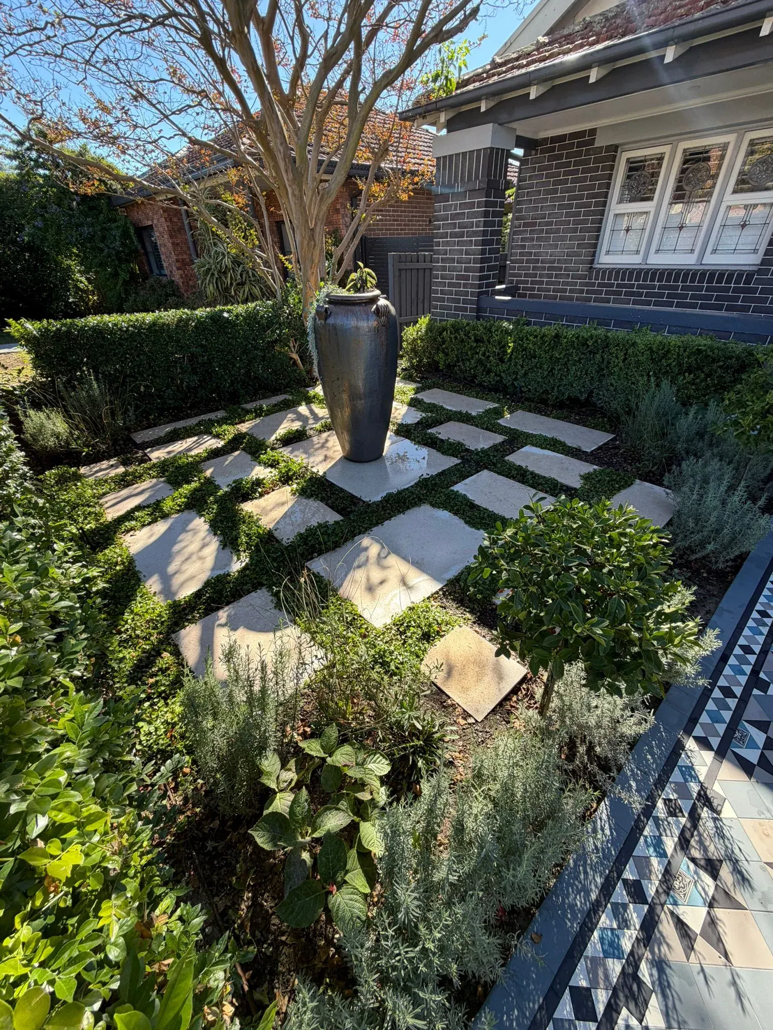 Landscaped garden beds, paving and lawn at Avalon Beach