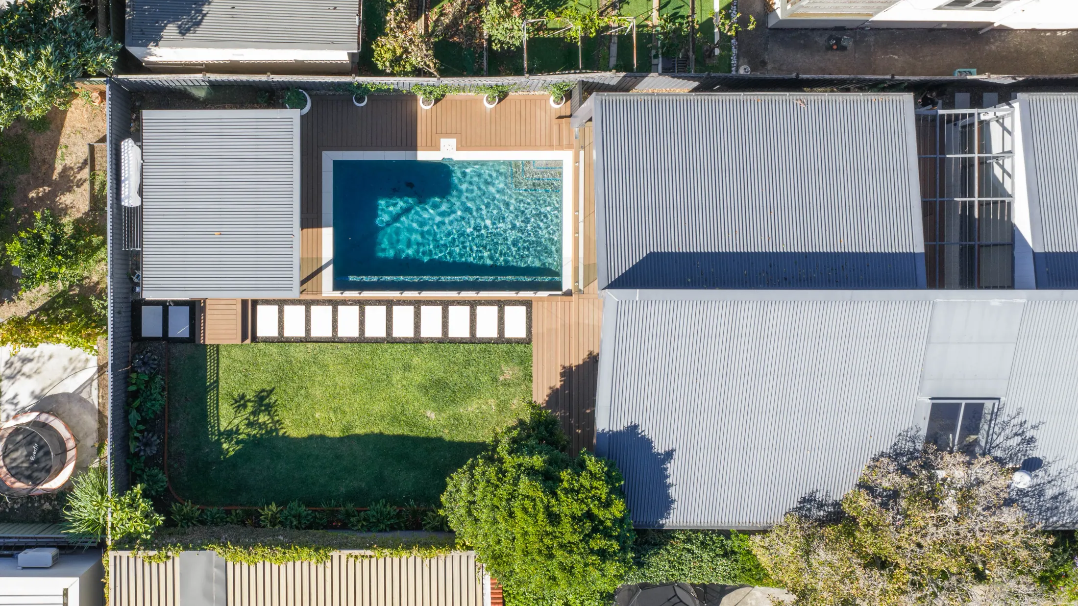 A landscaped garden and timber build by BM Carpentry at golden hour